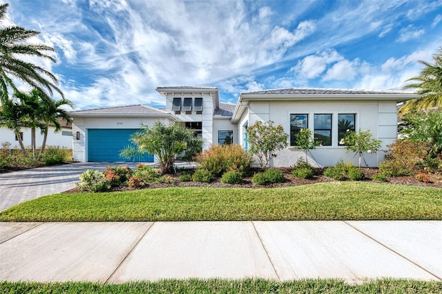 view of front facade featuring a garage and a front lawn