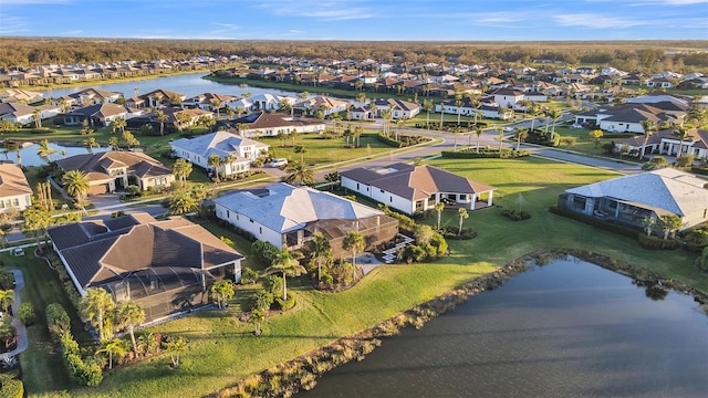 drone / aerial view featuring a residential view and a water view