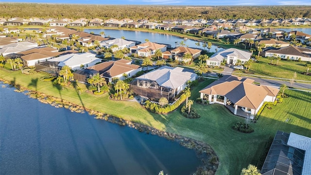 drone / aerial view with a residential view and a water view