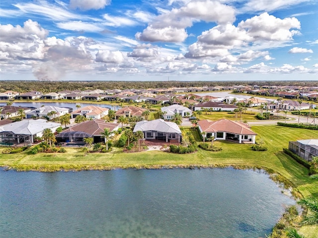 drone / aerial view with a water view and a residential view