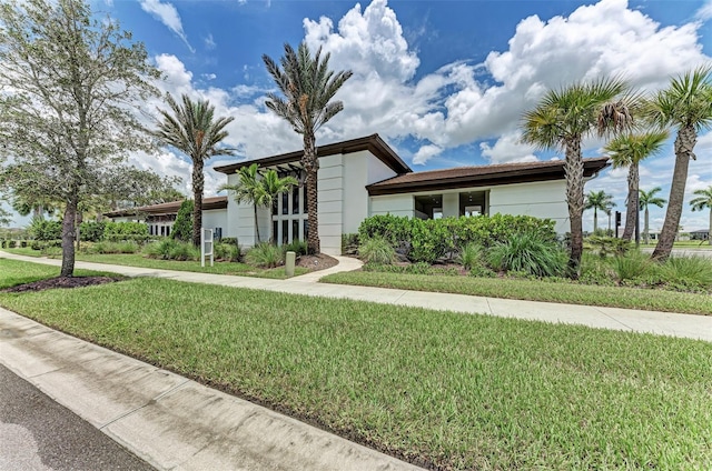 view of front of house featuring a front yard and stucco siding