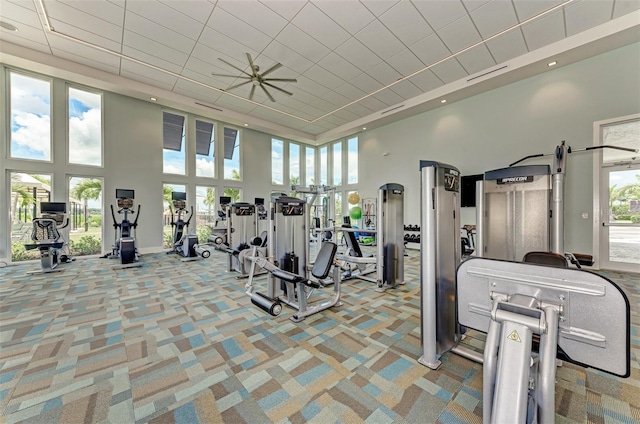 workout area featuring carpet floors, a towering ceiling, and visible vents