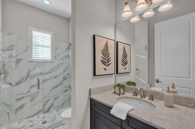 bathroom with a notable chandelier, toilet, vanity, and a marble finish shower