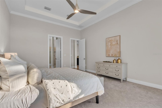 carpeted bedroom with a raised ceiling, ceiling fan, visible vents, and ornamental molding