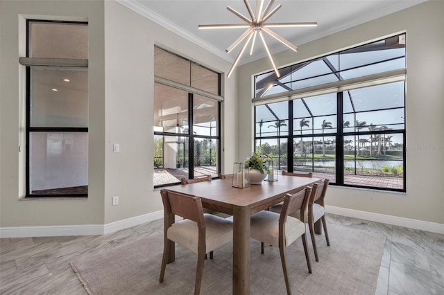 dining space with marble finish floor, a water view, crown molding, and baseboards