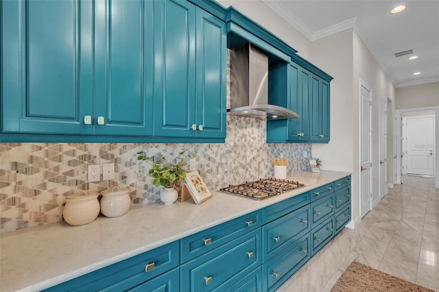 kitchen featuring stainless steel gas stovetop, marble finish floor, light countertops, wall chimney exhaust hood, and crown molding
