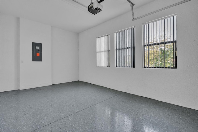 garage with electric panel and a garage door opener