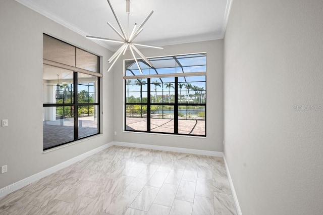 spare room with marble finish floor, a healthy amount of sunlight, crown molding, and baseboards