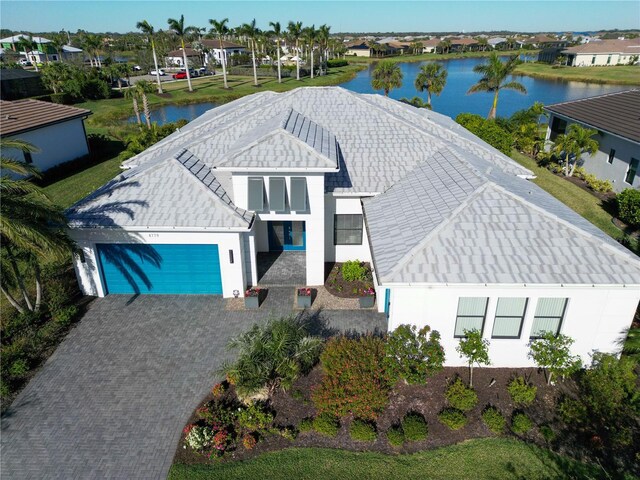 drone / aerial view featuring a water view and a residential view
