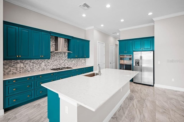 kitchen with wall chimney exhaust hood, a sink, decorative backsplash, an island with sink, and appliances with stainless steel finishes