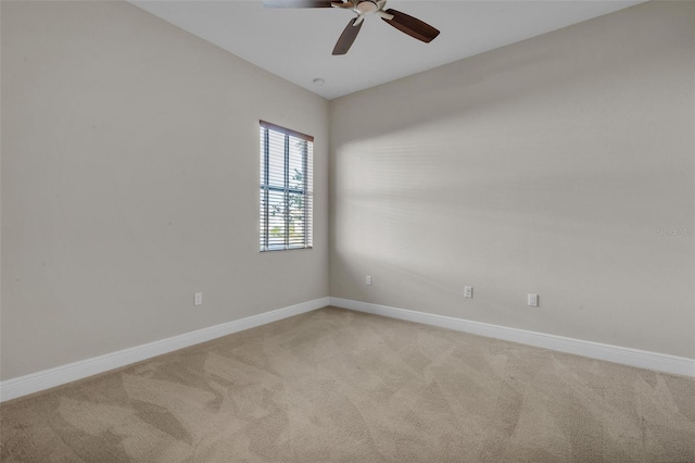 unfurnished room featuring ceiling fan, baseboards, and light colored carpet