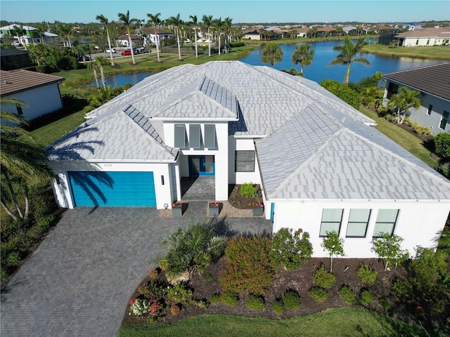 4779 Pastel Ct, Sarasota, FL 34240 - view of front of house with a garage, a residential view, driveway, a water view, and stucco siding