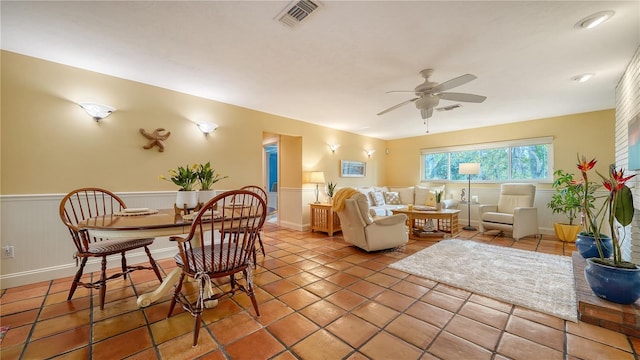 living room featuring ceiling fan and tile patterned floors