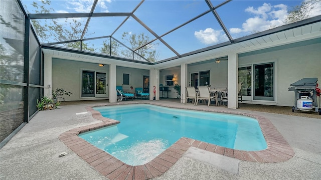 view of swimming pool with glass enclosure and a patio area