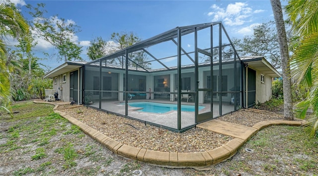 back of property featuring a lanai and a patio