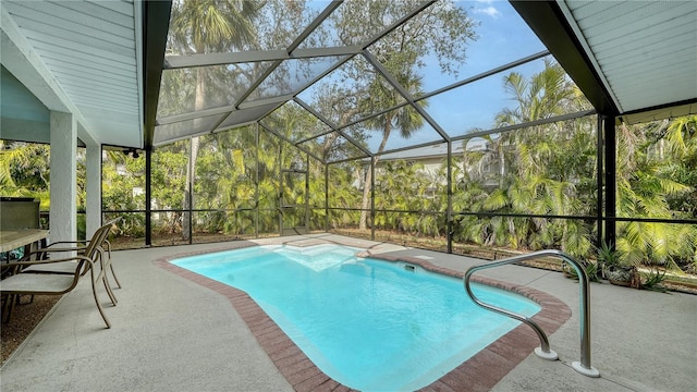 view of pool with a patio area and a lanai