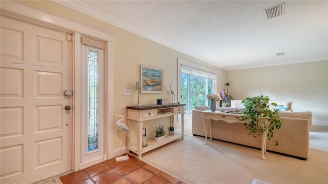 foyer with carpet and crown molding