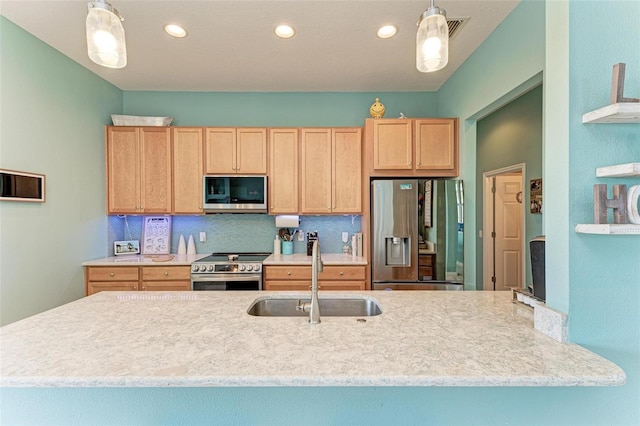 kitchen featuring pendant lighting, sink, tasteful backsplash, light brown cabinetry, and appliances with stainless steel finishes