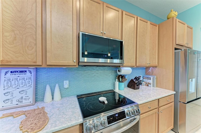 kitchen with tasteful backsplash, light brown cabinetry, and stainless steel appliances