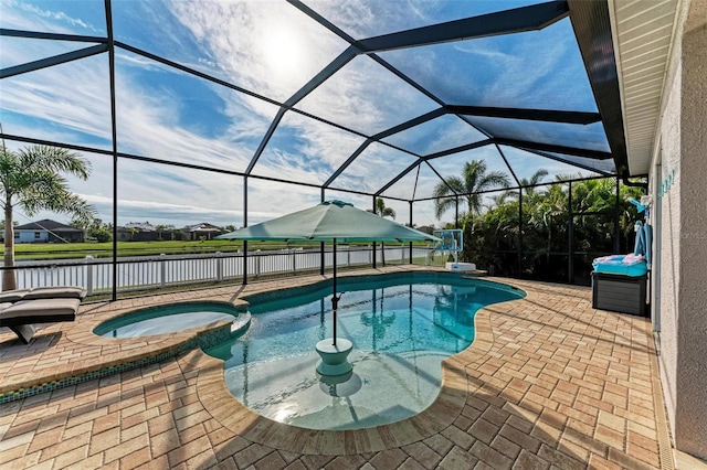 view of pool with a lanai, a patio area, and an in ground hot tub