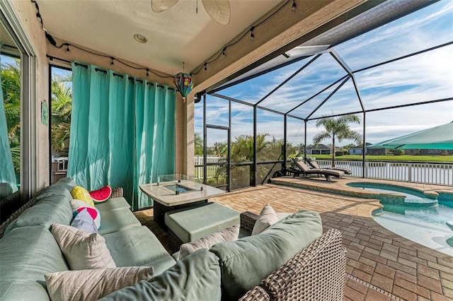 view of patio / terrace with glass enclosure, a water view, an outdoor hangout area, ceiling fan, and a swimming pool with hot tub