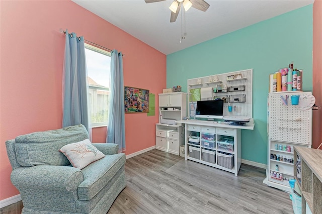 living area featuring light hardwood / wood-style flooring and ceiling fan