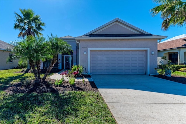 ranch-style home with concrete driveway, an attached garage, and stucco siding