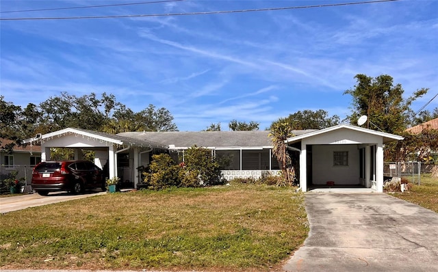 view of front of house with a carport and a front lawn