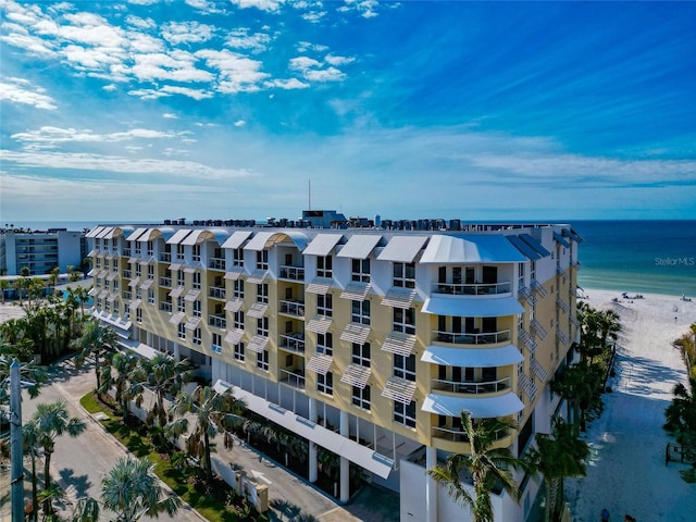 drone / aerial view featuring a water view and a beach view