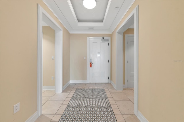 doorway to outside featuring a raised ceiling, crown molding, and light tile patterned floors