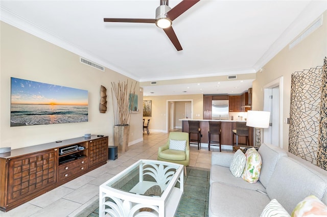 tiled living room featuring ceiling fan and ornamental molding