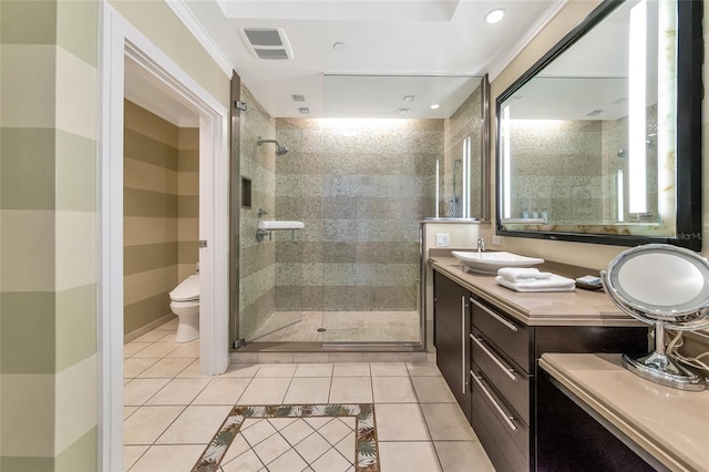 bathroom featuring tile patterned flooring, crown molding, toilet, vanity, and a shower with shower door