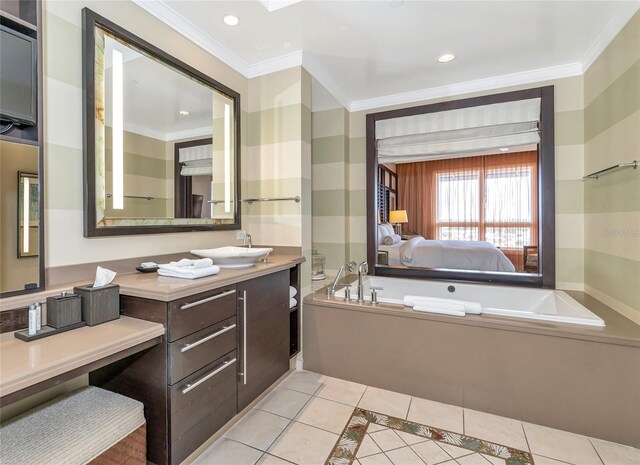 bathroom featuring tile patterned floors, vanity, crown molding, and a washtub