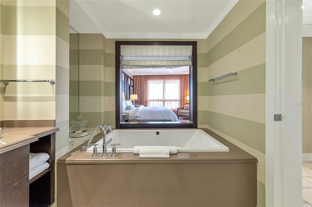 bathroom featuring tile patterned flooring, vanity, a bathtub, and ornamental molding