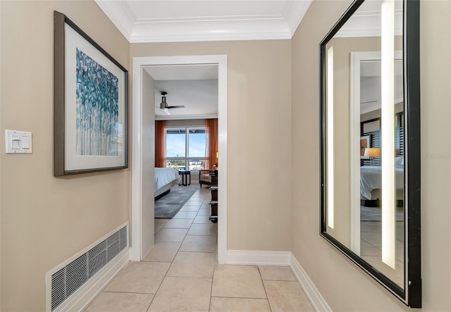 hall featuring crown molding and light tile patterned flooring