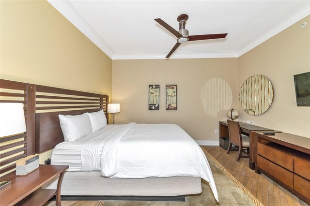 bedroom featuring hardwood / wood-style floors, ceiling fan, and crown molding