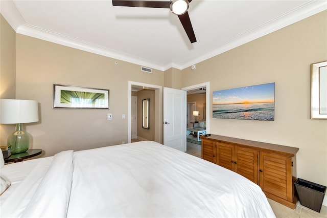 tiled bedroom with ceiling fan and ornamental molding