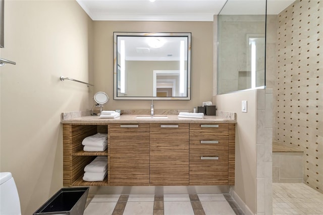 bathroom with vanity, tile patterned floors, crown molding, toilet, and tiled shower