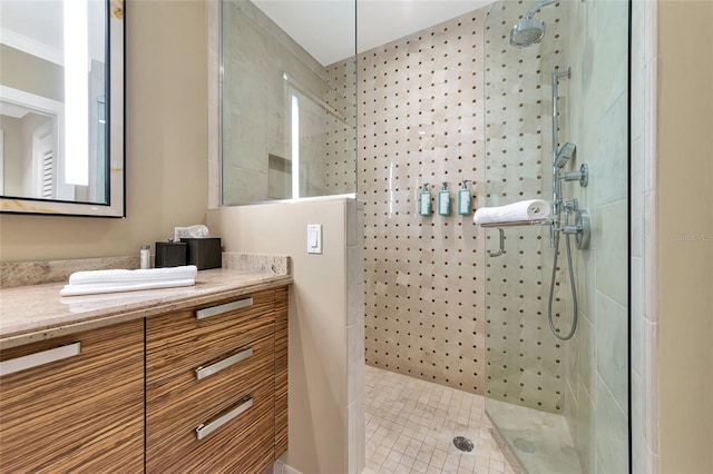 bathroom featuring a shower, vanity, and ornamental molding