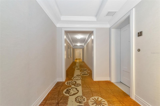 corridor with light tile patterned floors and crown molding