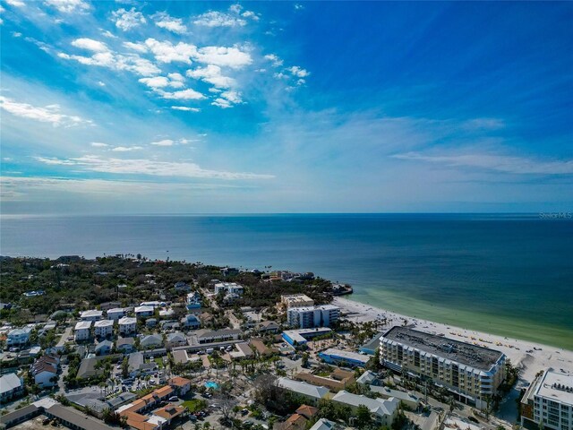 birds eye view of property with a water view and a beach view