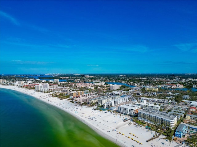 birds eye view of property with a water view and a beach view