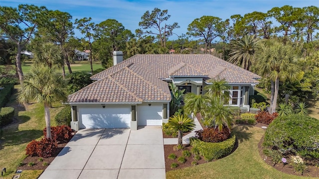 mediterranean / spanish house featuring a garage