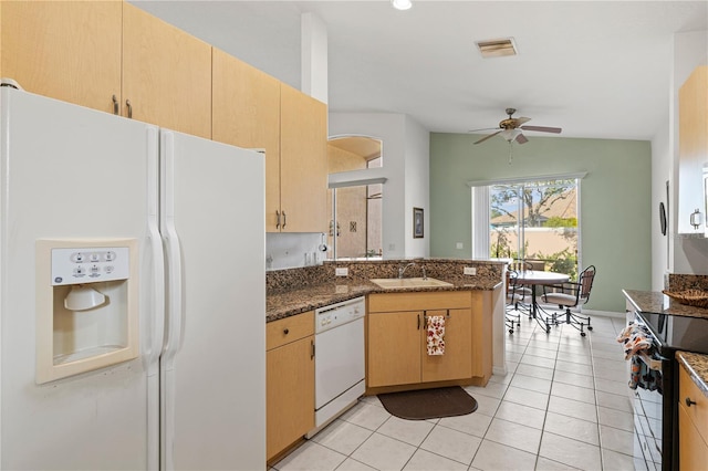 kitchen featuring dark stone countertops, ceiling fan, light brown cabinets, and white appliances