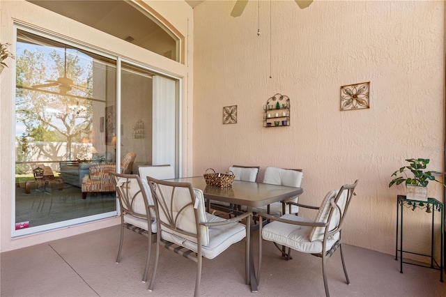 dining space featuring ceiling fan and concrete flooring