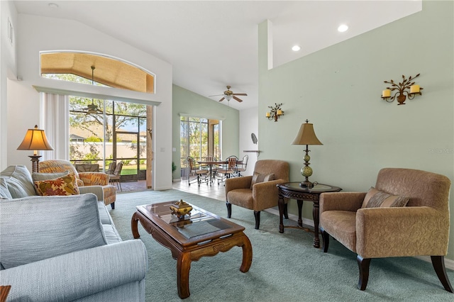 living room with ceiling fan, light carpet, and high vaulted ceiling