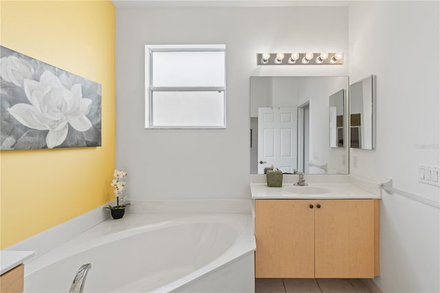 bathroom featuring tile patterned flooring, vanity, and a tub to relax in