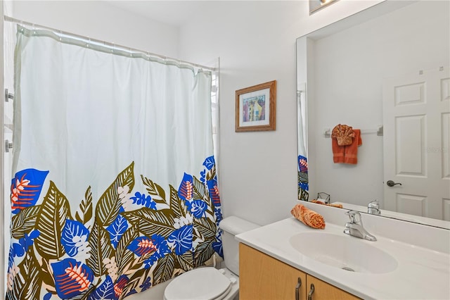 bathroom featuring vanity, toilet, and walk in shower