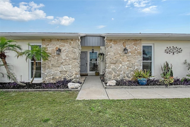 property entrance with a yard