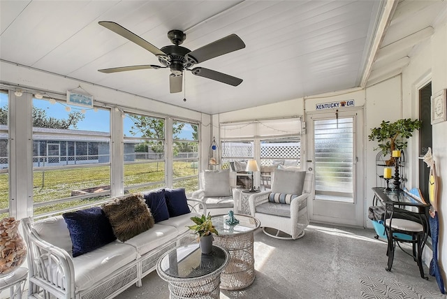 sunroom / solarium with ceiling fan and lofted ceiling